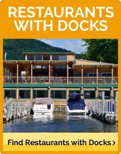 View taken from the water of a restaurant with docks on Lake George