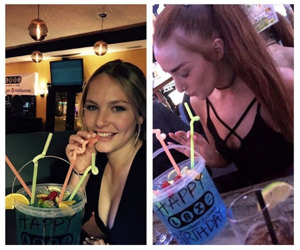 two girls drinking out of birthday buckets