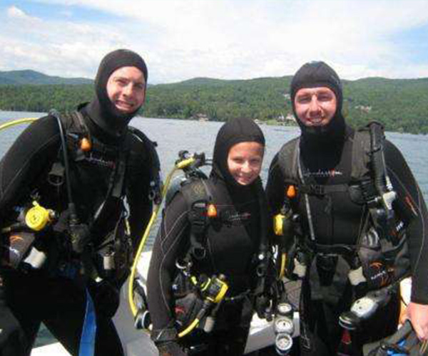 three people in scuba suits