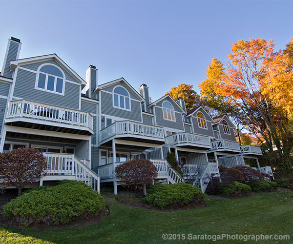 blue townhouses with fall foliage