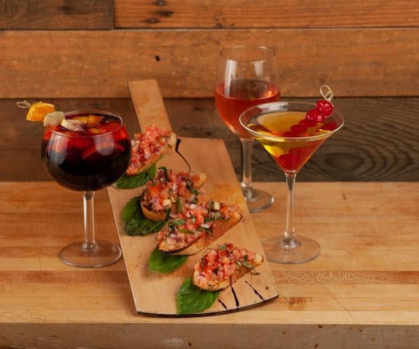 cocktail glasses with bruschetta on a platter