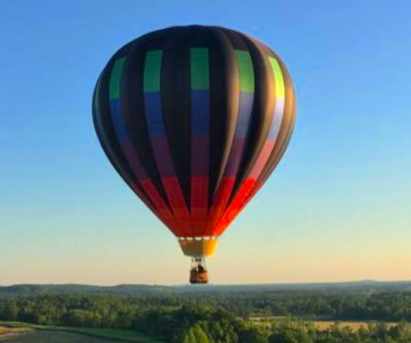 rainbow-colored balloon in the sky