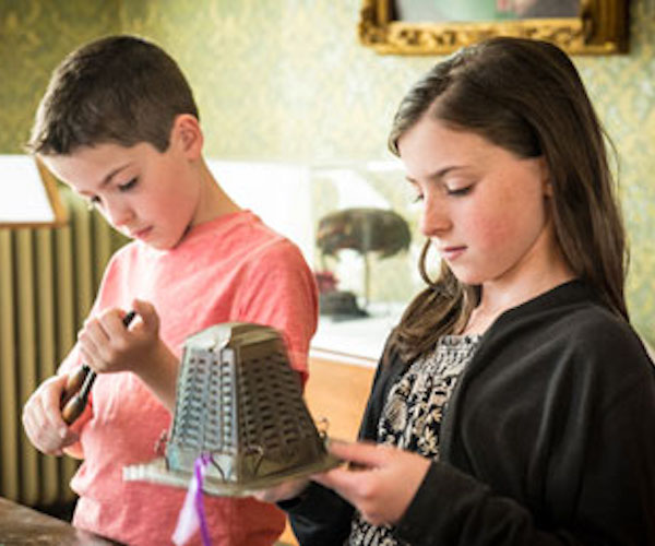 kids holding objects at Chapman Museum