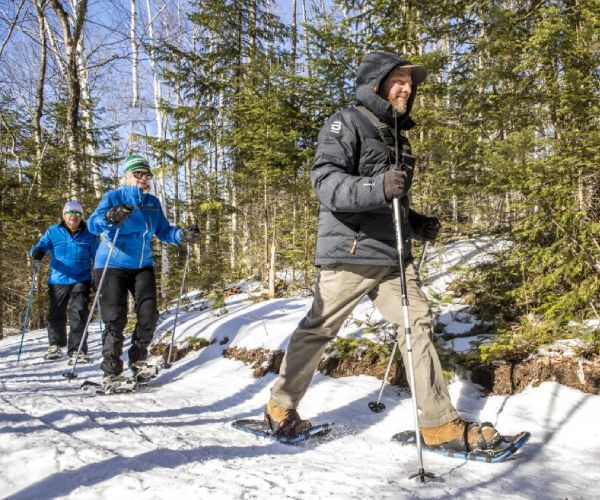 three snowshoers