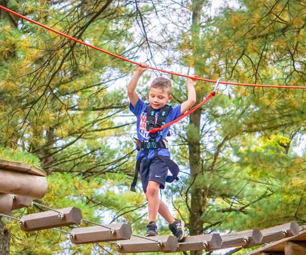 boy on an aerial ropes course