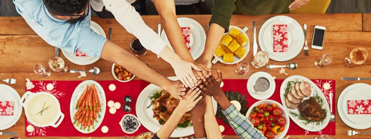 hands reaching over food to join together