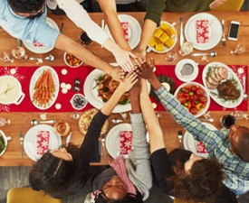 hands reaching over food to join together