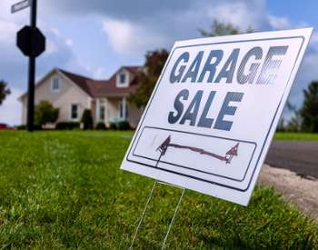 garage sale sign in front of house