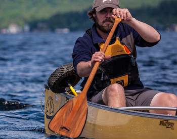 man paddling in a canoe