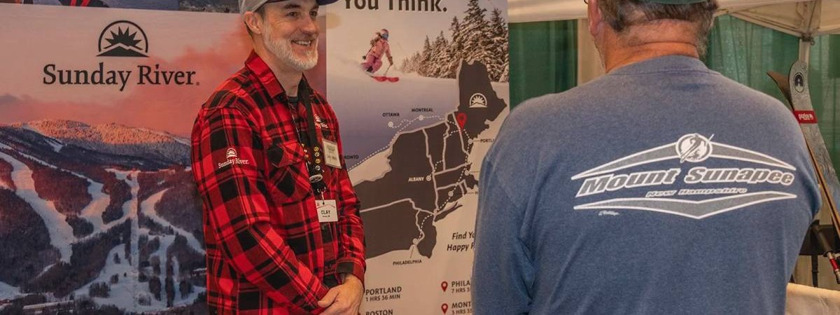 people talking at ski booth