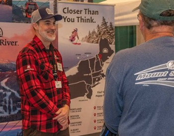 people talking at ski booth