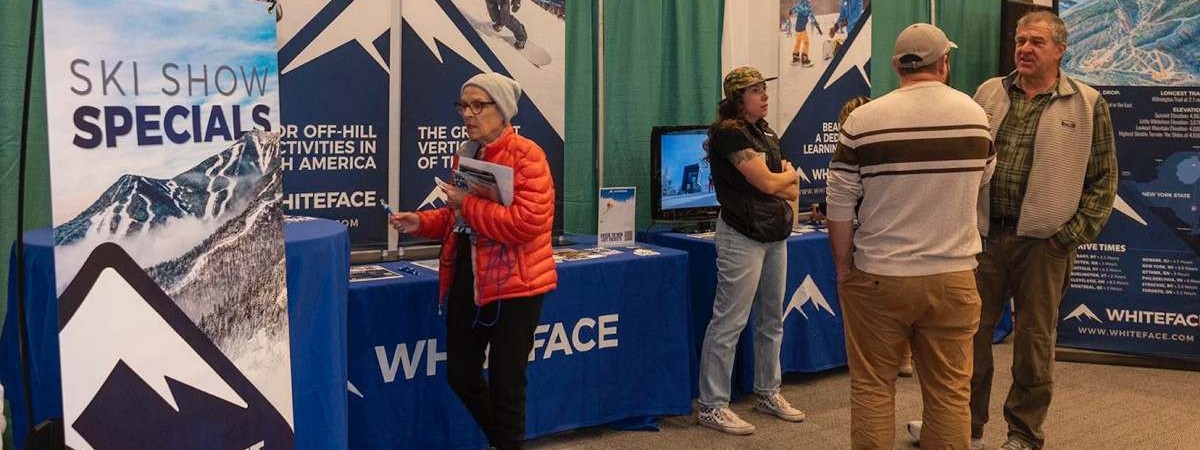 people talking at ski booth
