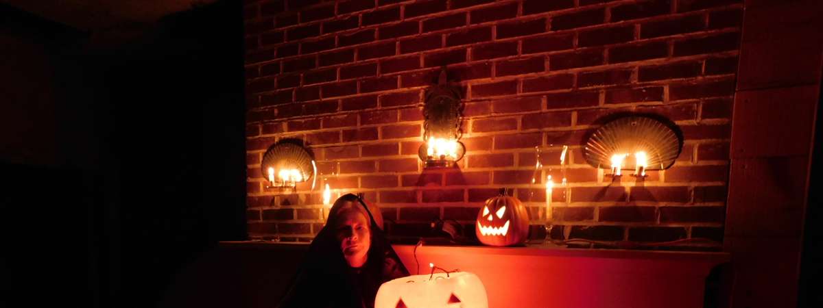 lit up pumpkins and woman