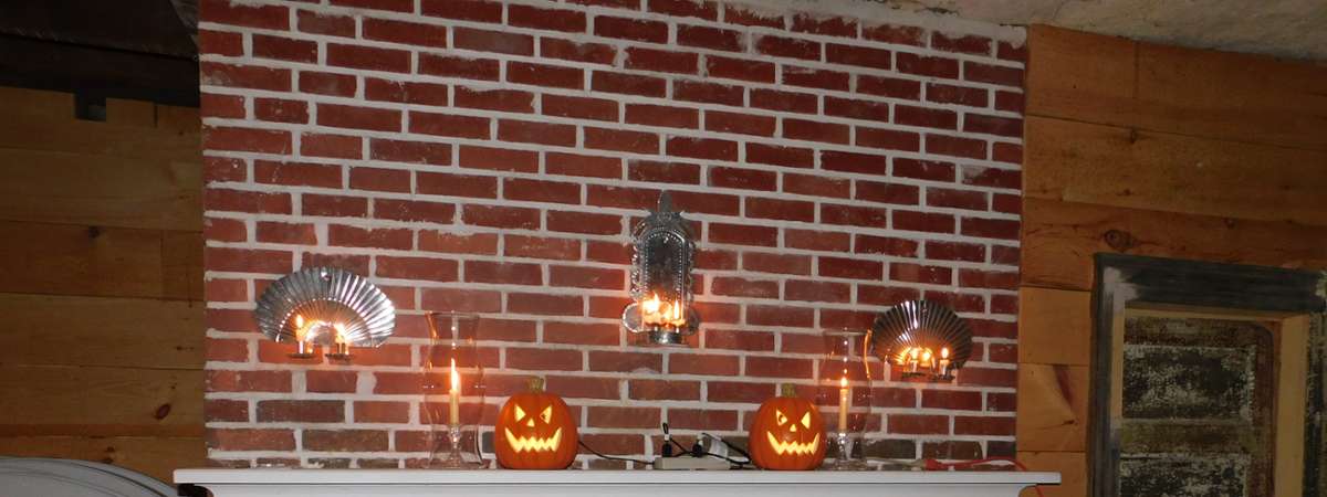 small jack o lanterns on fireplace ledge