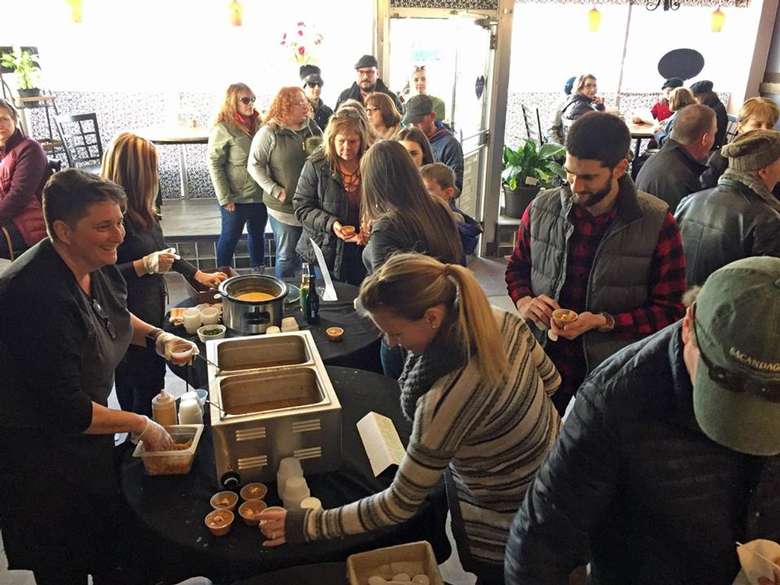 restaurant staff serving soup samples to customers