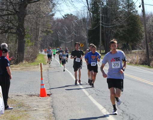 a line of runners on a road