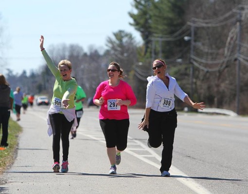 three women running together in a race