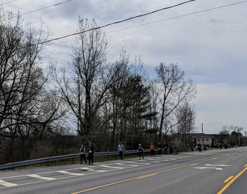 people running a 5k down a road