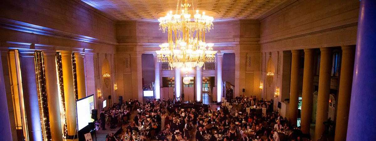 tables of people inside the hall of springs for a gala