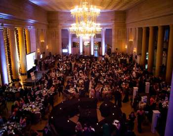 tables of people inside the hall of springs for a gala