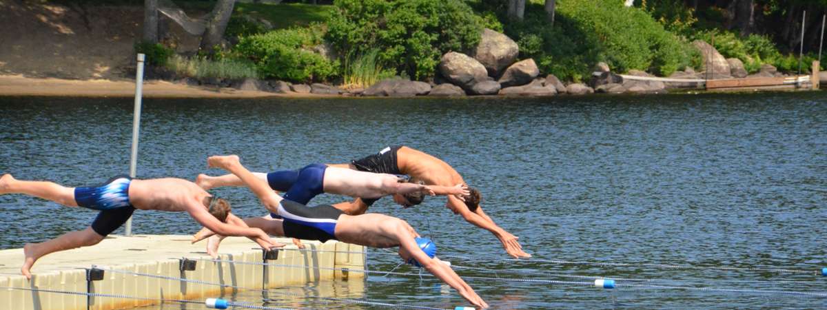 people diving into lake