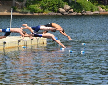 people diving into lake