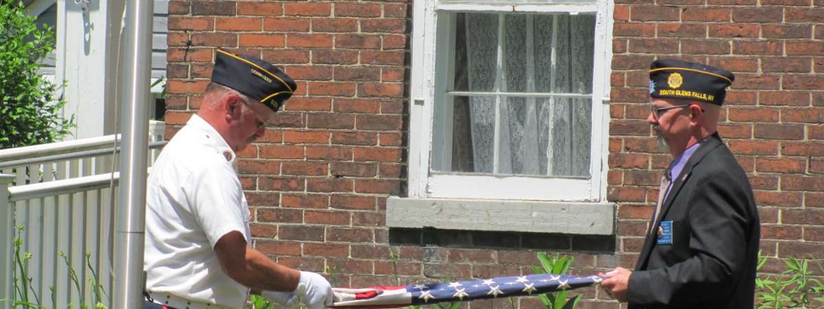 People Folding Flag Photo