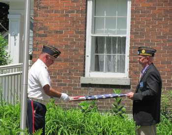People Folding Flag Photo