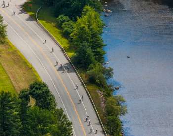 aerial view of bikers next to a river