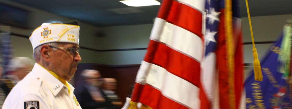 Veteran Holding Flag Photo