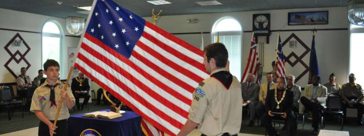 two people managing american flag