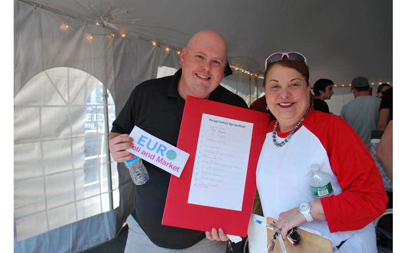 two people holding up a sign up sheet