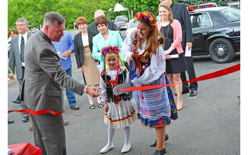 a red ribbon cutting at a polish festival