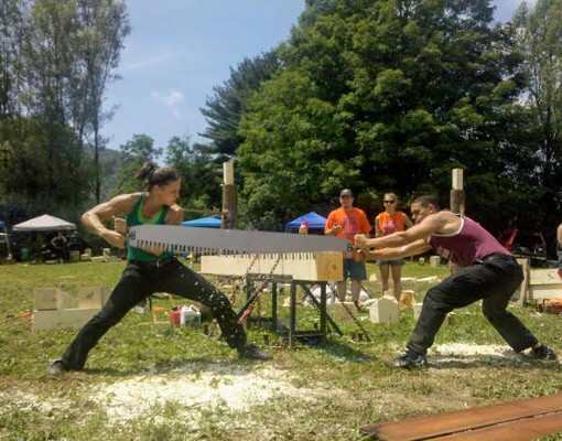 people sawing lumber