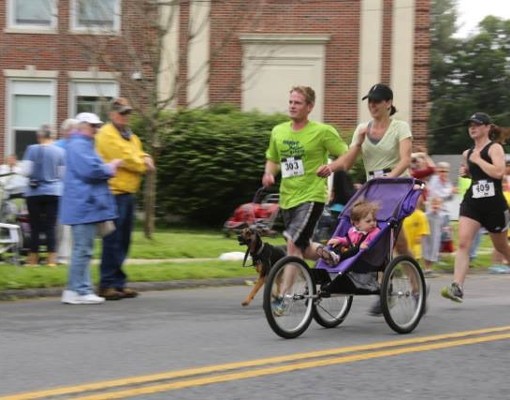 people in street, one with a stroller