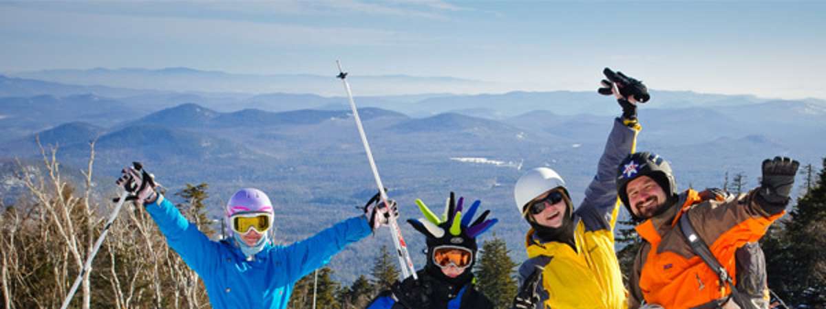four people on skis at a ski mountain
