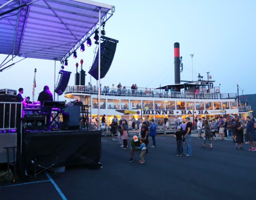 a festival happening near some large steamboats