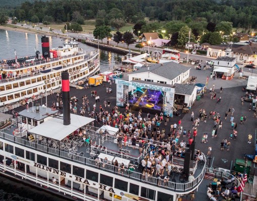 crowds watching bands play on the steamboat pier