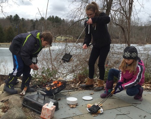 people roasting s'mores