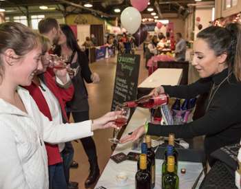 Photo of a booth serving wine at the Albany Wine & Chocolate Festival