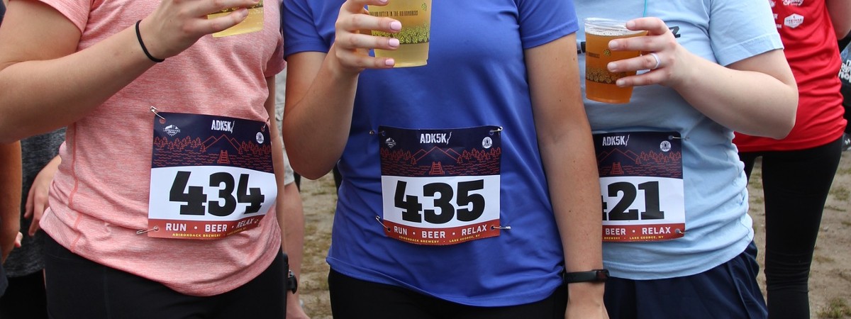 people holding beer after a race