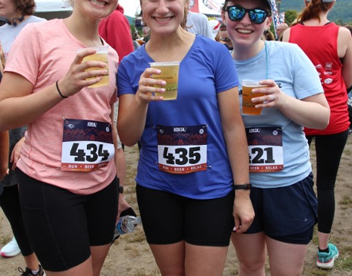 people holding beer after a race