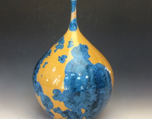 a fancy blue vase with yellow coloring