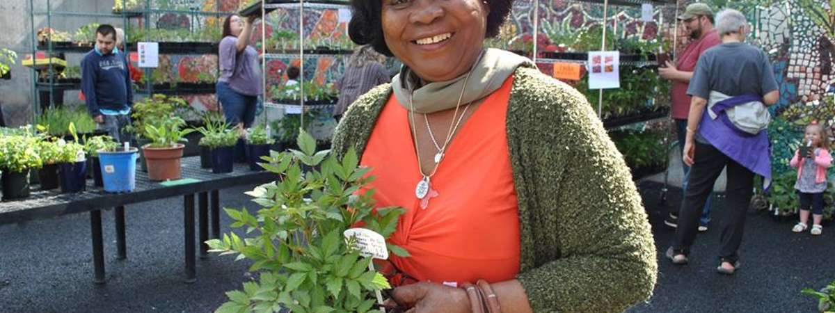 Photo of woman holding plant