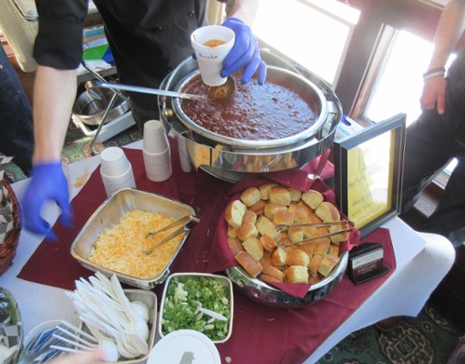 table with chili, toppings, bread