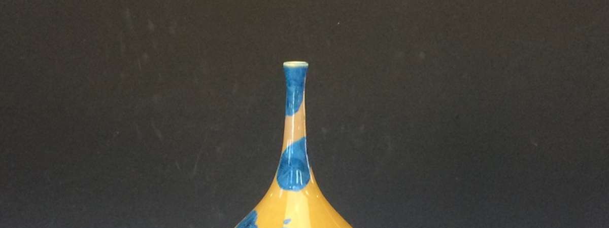 a fancy blue vase with yellow coloring