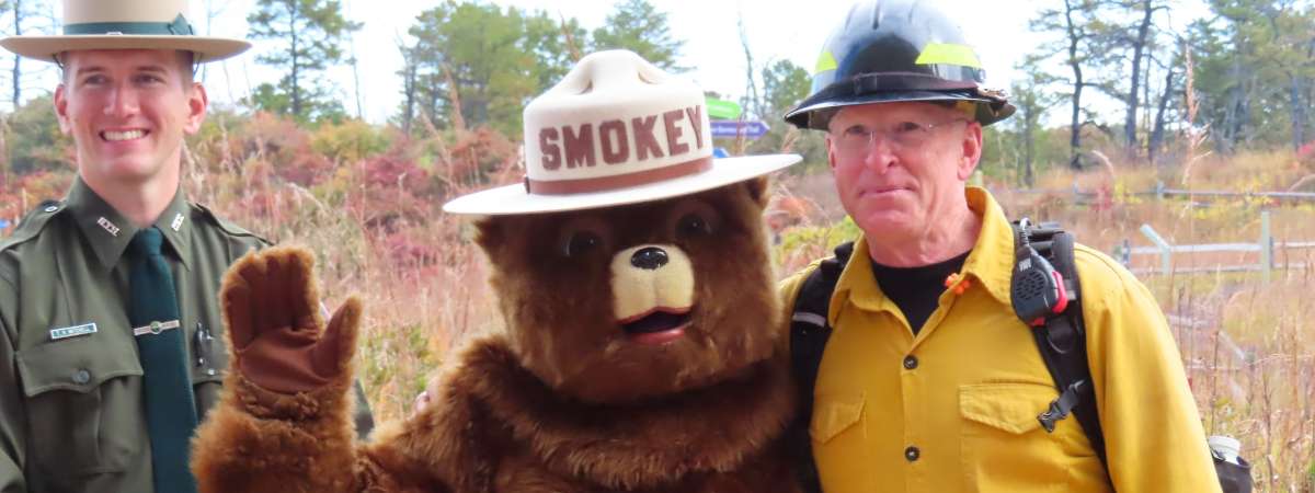 park staff standing with smokey the bear
