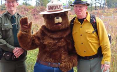 park staff standing with smokey the bear