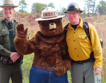 park staff standing with smokey the bear