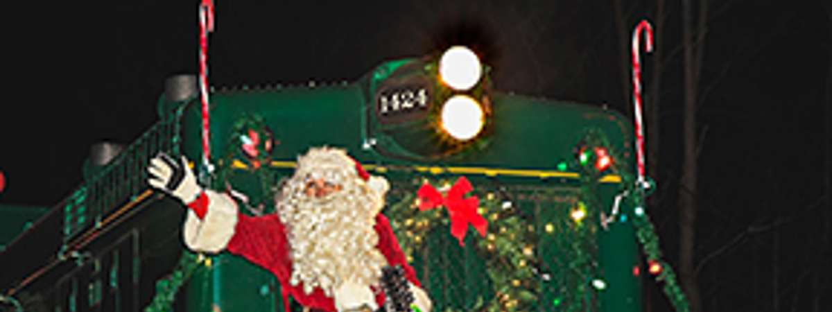Photo of santa in front of a train